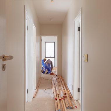 a couple of men working on a house