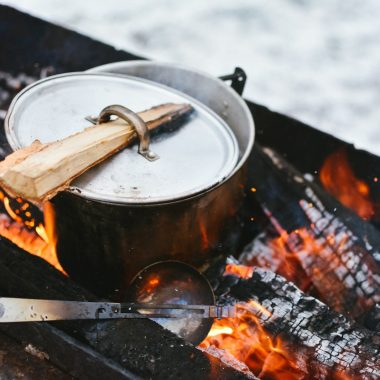 silver cook pot on firewood