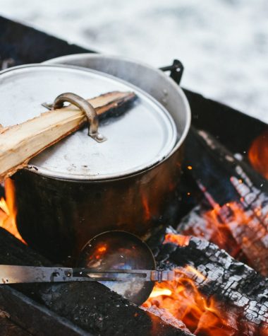 silver cook pot on firewood